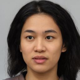 Joyful asian young-adult female with medium  black hair and brown eyes