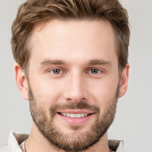 Joyful white young-adult male with short  brown hair and brown eyes