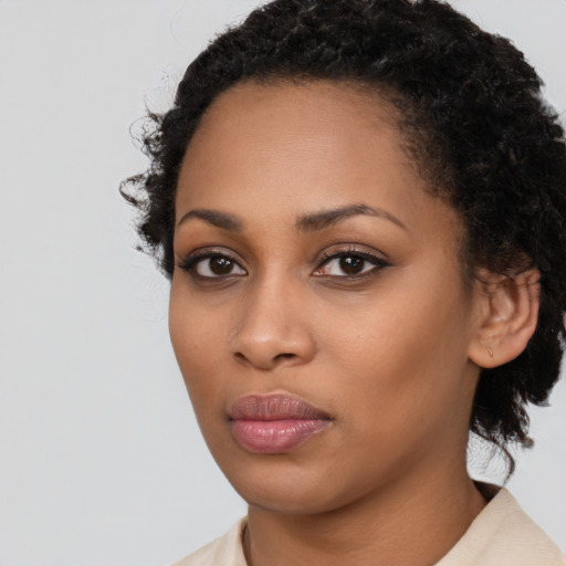 Neutral black young-adult female with medium  black hair and brown eyes