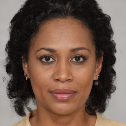 Joyful black young-adult female with medium  brown hair and brown eyes