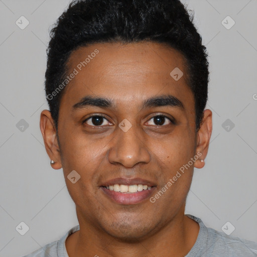 Joyful black young-adult male with short  black hair and brown eyes