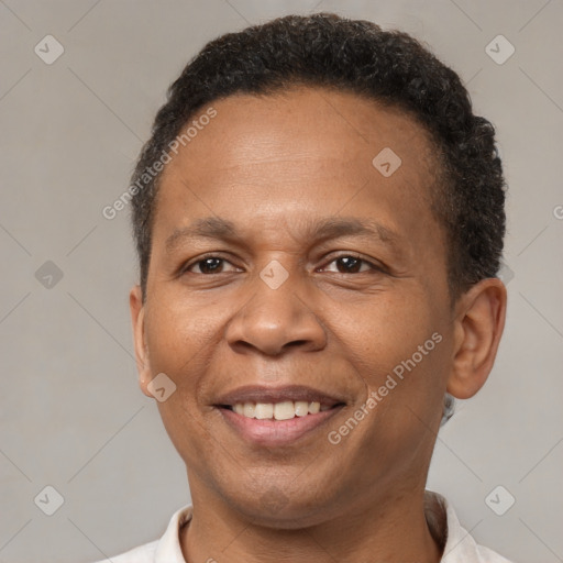 Joyful latino adult male with short  brown hair and brown eyes