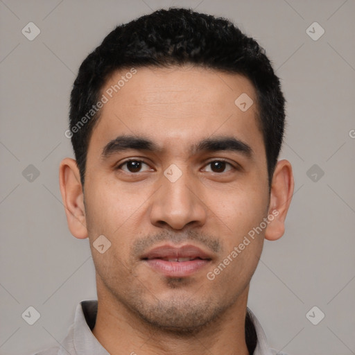 Joyful latino young-adult male with short  black hair and brown eyes