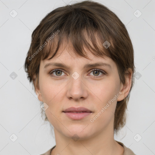 Joyful white young-adult female with medium  brown hair and grey eyes