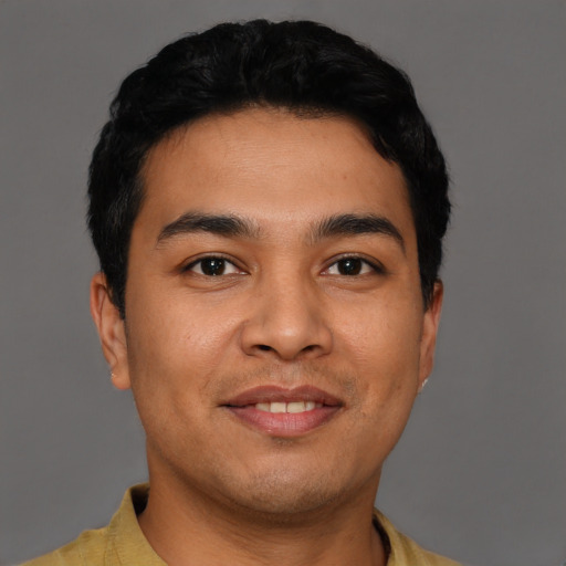 Joyful latino young-adult male with short  black hair and brown eyes