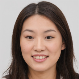 Joyful asian young-adult female with long  brown hair and brown eyes