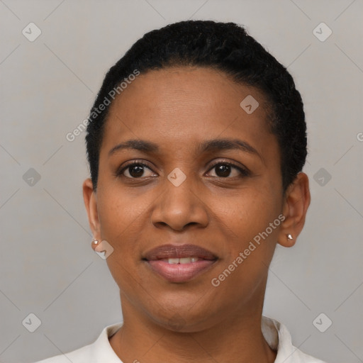 Joyful black young-adult female with short  black hair and brown eyes