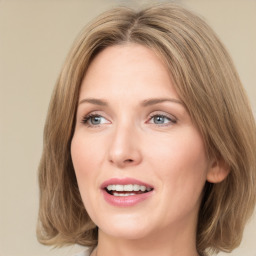 Joyful white young-adult female with medium  brown hair and green eyes