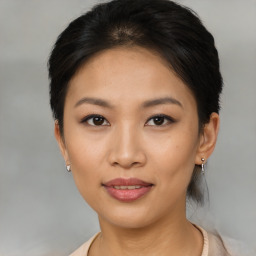 Joyful asian young-adult female with short  black hair and brown eyes