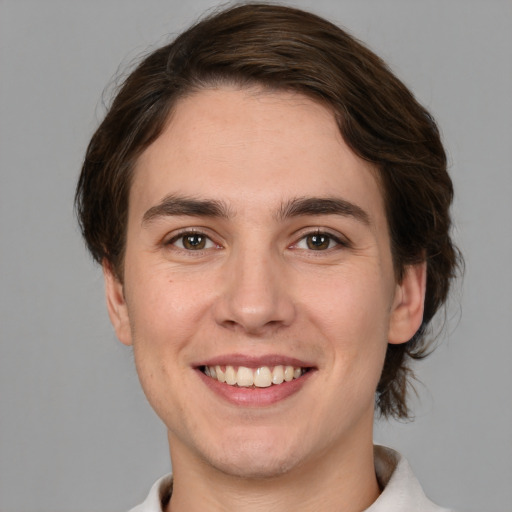 Joyful white young-adult male with medium  brown hair and brown eyes