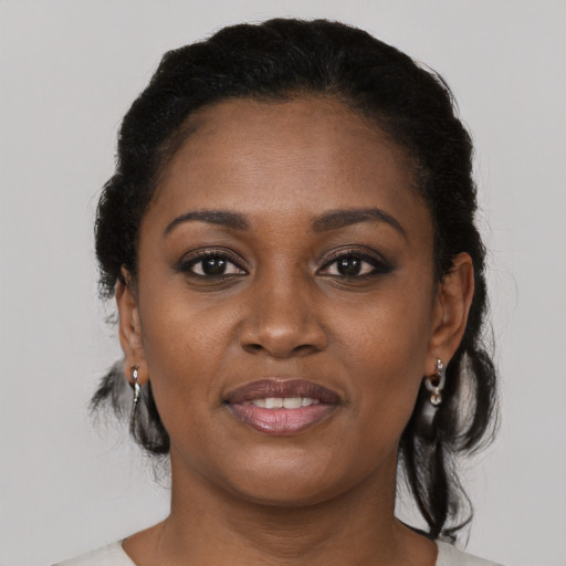 Joyful black young-adult female with medium  black hair and brown eyes