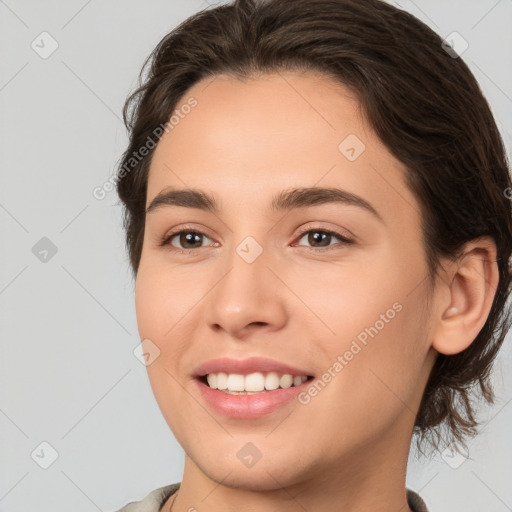 Joyful white young-adult female with medium  brown hair and brown eyes