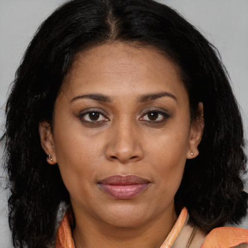 Joyful latino adult female with long  brown hair and brown eyes