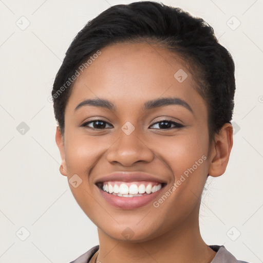 Joyful latino young-adult female with short  black hair and brown eyes