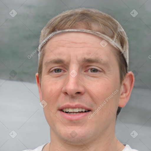 Joyful white adult male with short  brown hair and grey eyes