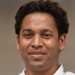 Joyful latino adult male with short  brown hair and brown eyes