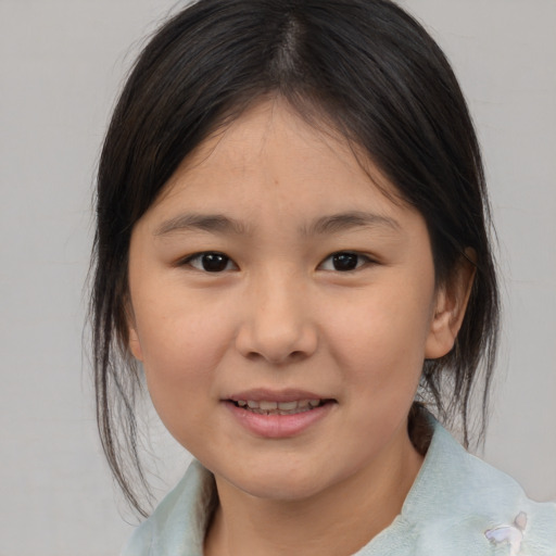 Joyful asian child female with medium  brown hair and brown eyes