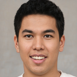 Joyful asian young-adult male with short  brown hair and brown eyes