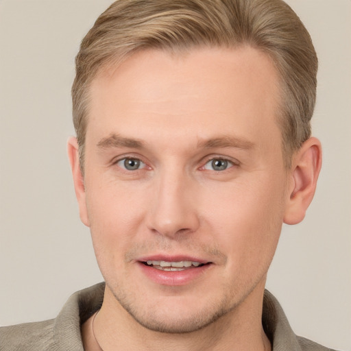 Joyful white adult male with short  brown hair and grey eyes