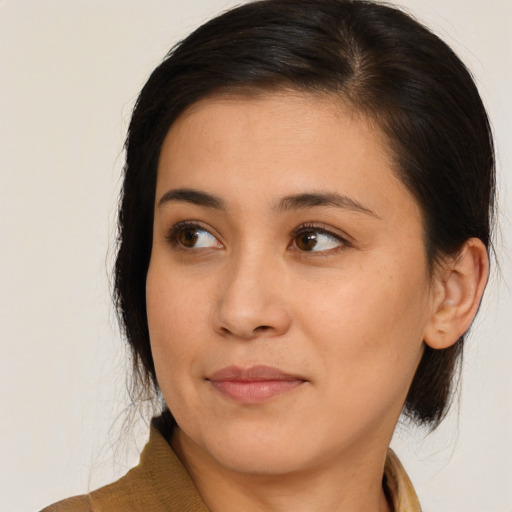 Joyful asian young-adult female with medium  brown hair and brown eyes