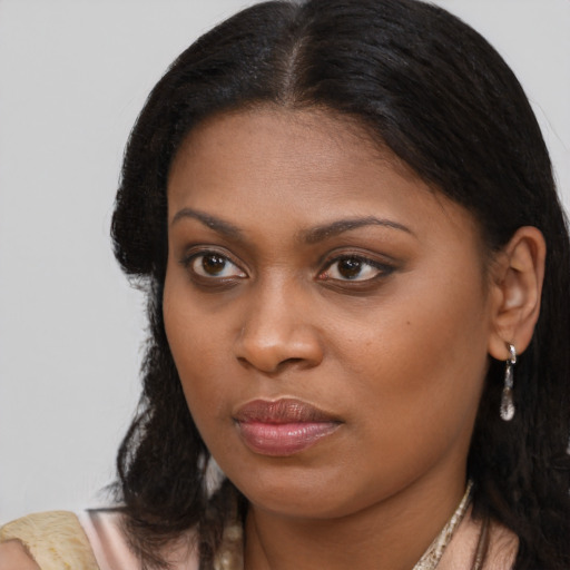 Joyful black young-adult female with medium  brown hair and brown eyes