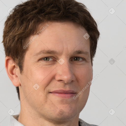 Joyful white adult male with short  brown hair and grey eyes