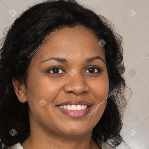 Joyful black young-adult female with long  brown hair and brown eyes