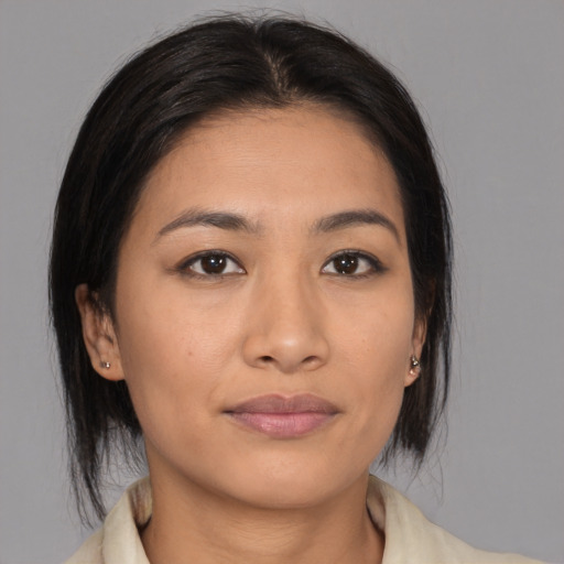 Joyful asian young-adult female with medium  brown hair and brown eyes