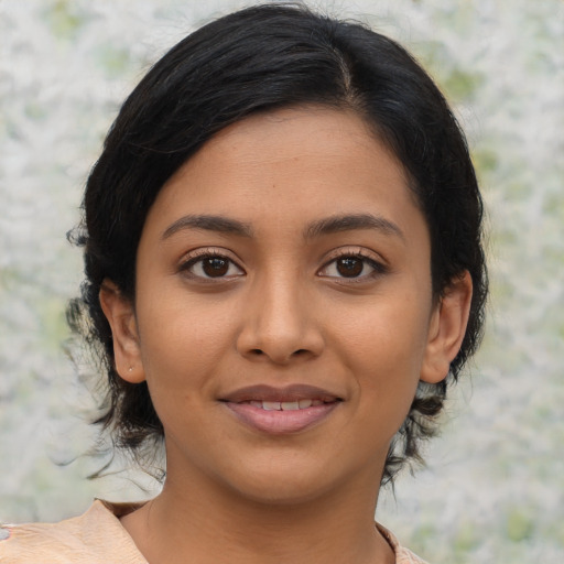 Joyful latino young-adult female with medium  black hair and brown eyes