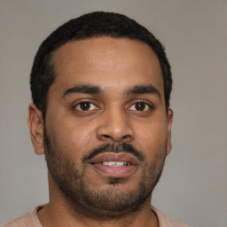 Joyful latino young-adult male with short  black hair and brown eyes