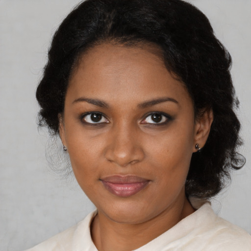 Joyful black young-adult female with medium  brown hair and brown eyes