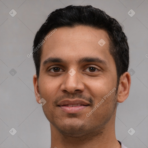 Joyful latino young-adult male with short  black hair and brown eyes