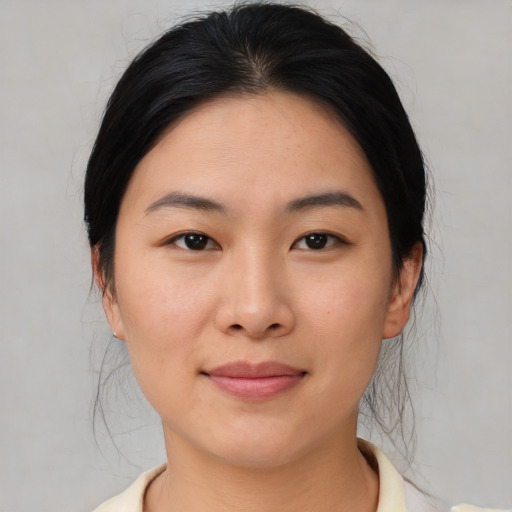 Joyful asian young-adult female with medium  brown hair and brown eyes