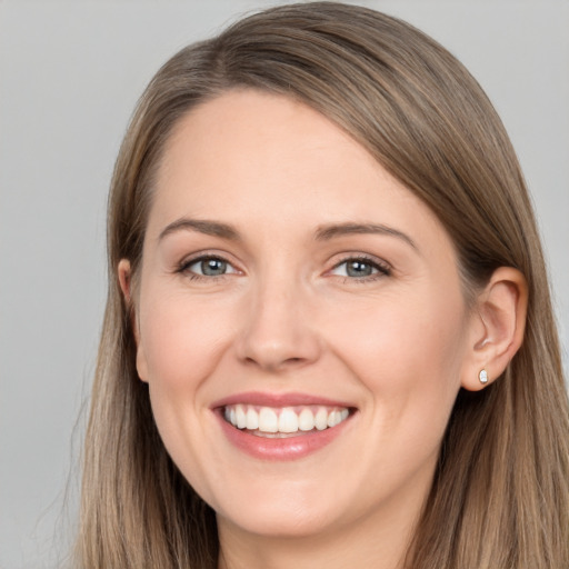 Joyful white young-adult female with long  brown hair and grey eyes