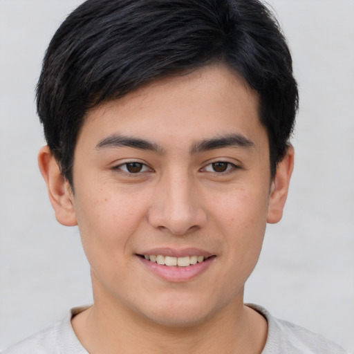 Joyful asian young-adult male with short  brown hair and brown eyes