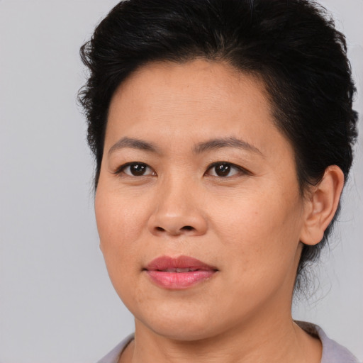 Joyful asian adult female with short  brown hair and brown eyes