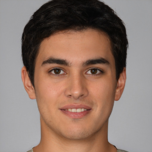 Joyful latino young-adult male with short  brown hair and brown eyes