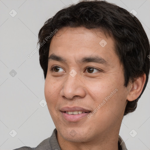 Joyful white adult male with short  brown hair and brown eyes