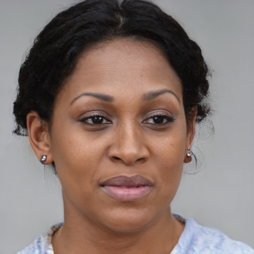 Joyful black young-adult female with medium  brown hair and brown eyes