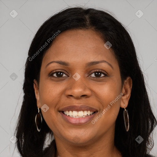 Joyful black young-adult female with long  brown hair and brown eyes