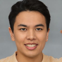 Joyful asian young-adult male with short  brown hair and brown eyes