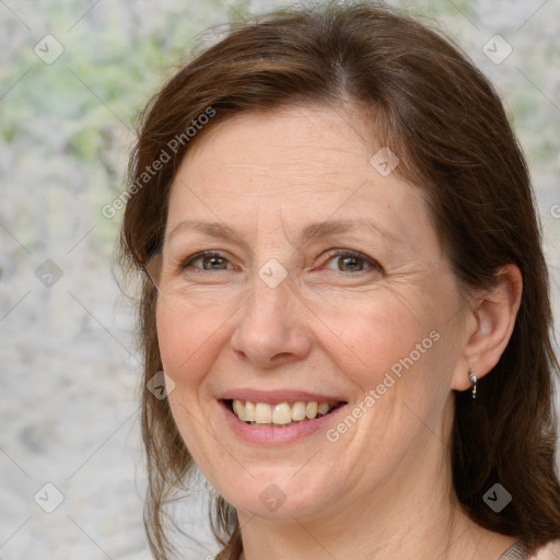 Joyful white adult female with medium  brown hair and grey eyes