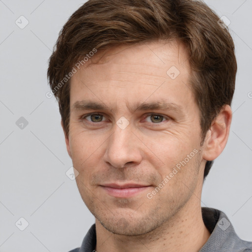 Joyful white adult male with short  brown hair and grey eyes