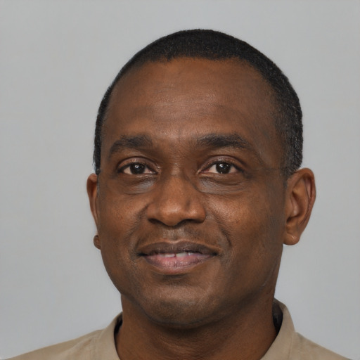 Joyful black adult male with short  black hair and brown eyes