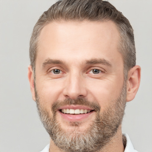 Joyful white adult male with short  brown hair and brown eyes