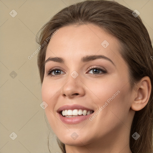 Joyful white young-adult female with long  brown hair and green eyes