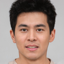 Joyful asian young-adult male with short  brown hair and brown eyes