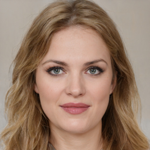 Joyful white young-adult female with long  brown hair and green eyes