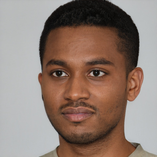 Joyful latino young-adult male with short  brown hair and brown eyes