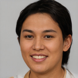 Joyful latino young-adult female with medium  brown hair and brown eyes